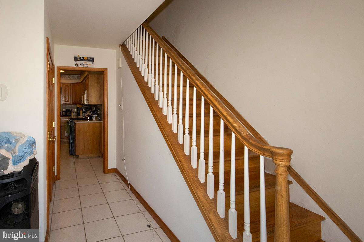 8 Franklin Road Glassboro, NJ 08028 - Photo 17 of 40 a view of a hallway with wooden floor and staircase