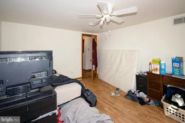 a bedroom with furniture and a wooden floor