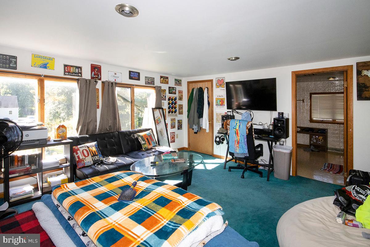 8 Franklin Road Glassboro, NJ 08028 - Photo 30 of 40 a living room with furniture a rug and a flat screen tv