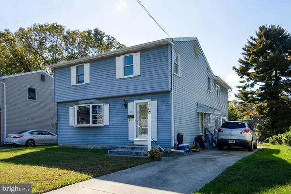 a view of a house with a backyard