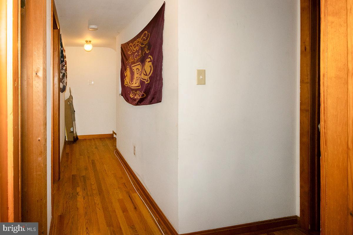 8 Franklin Road Glassboro, NJ 08028 - Photo 37 of 40 a view of a hallway with wooden floor