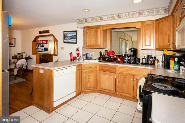 a view of a kitchen with fridge and workspace