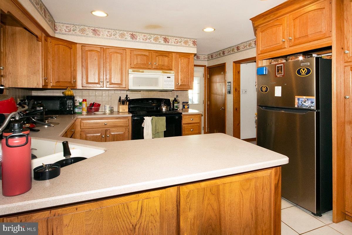 8 Franklin Road Glassboro, NJ 08028 - Photo 6 of 40 a kitchen with kitchen island a sink appliances and cabinets