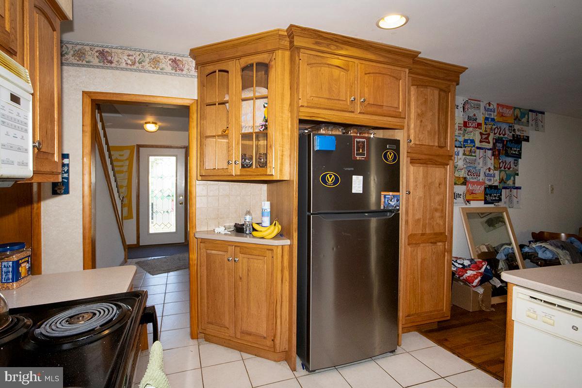 8 Franklin Road Glassboro, NJ 08028 - Photo 7 of 40 a kitchen with stainless steel appliances granite countertop a refrigerator and a stove top oven