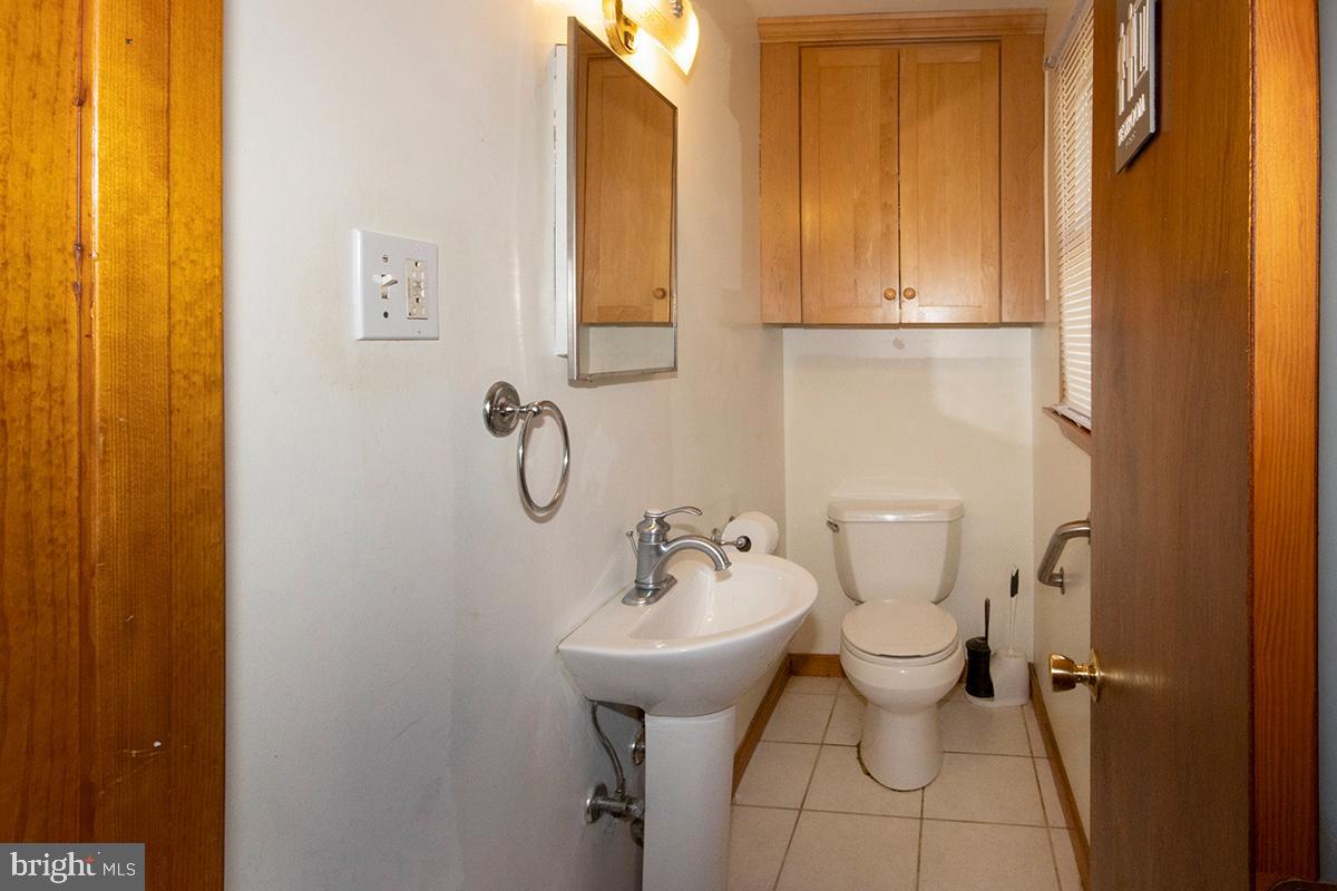 8 Franklin Road Glassboro, NJ 08028 - Photo 10 of 40 a bathroom with a sink a toilet and mirror