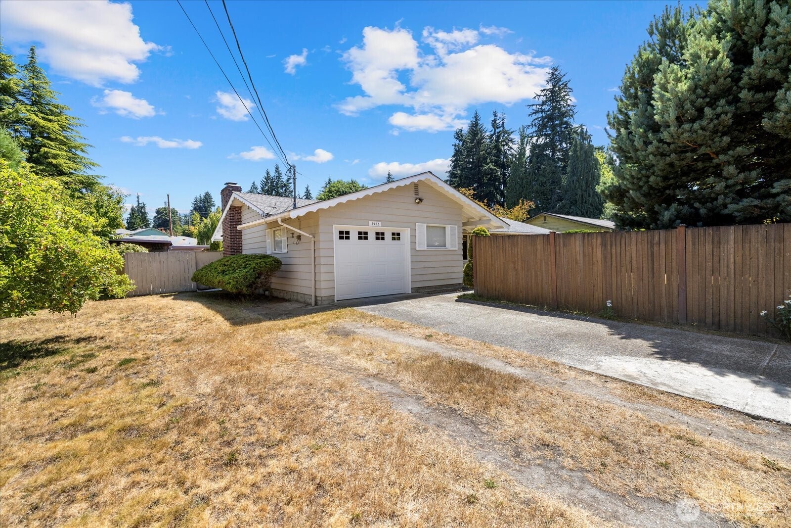 9125 Meadow Way Everett, WA 98208 - Photo 2 of 27 a front view of a house with a yard