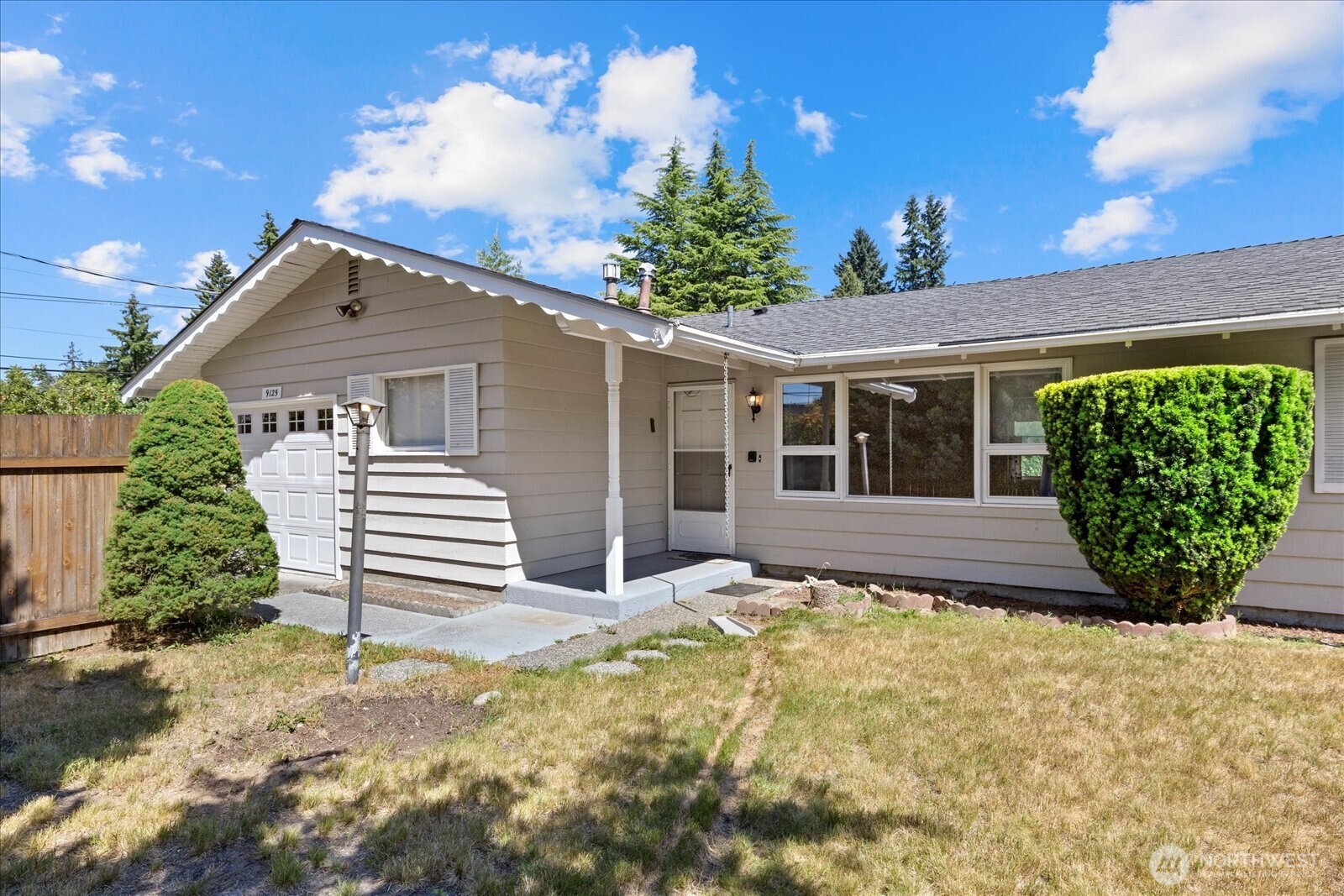 9125 Meadow Way Everett, WA 98208 - Photo 4 of 27 a view of a house with a large window and potted plants