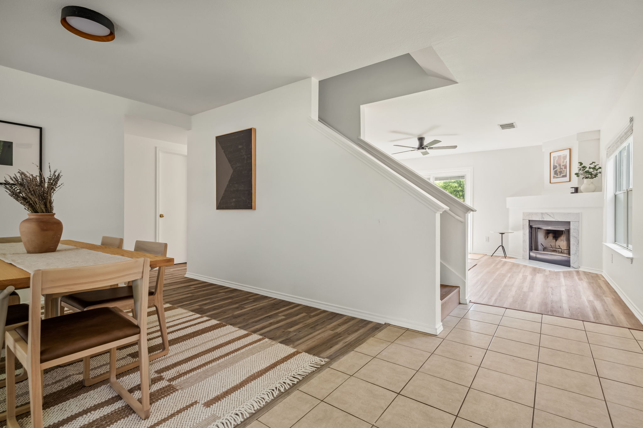 1408 Water Spaniel Way Round Rock, TX 78664 - Photo 36 of 37 An open floorplan seamlessly connects the dining area to the living room with a fireplace and staircase.