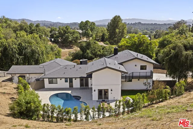 a aerial view of a house next to a yard