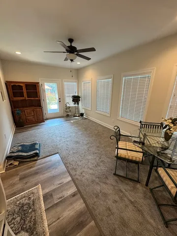 a living room with furniture a air conditioner vent and a window