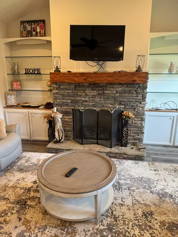 a picture of a living room with a fireplace