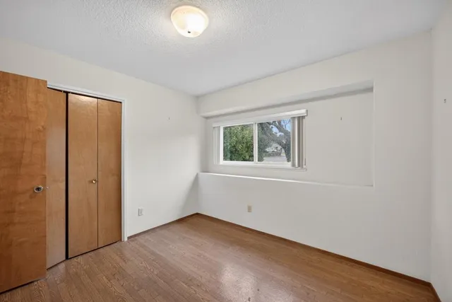 an empty room with windows and closet