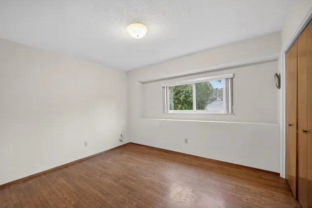 a bathroom with a granite countertop sink a toilet and a mirror