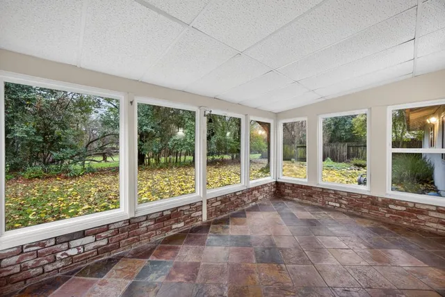 a view of a house with a large tree and a yard