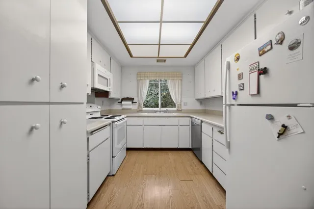 a kitchen with stainless steel appliances white cabinets and a stove