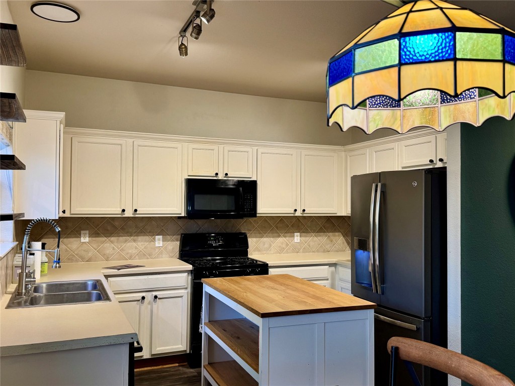 2308 Sweet Clover Drive Austin, TX 78745 - Photo 13 of 30 a kitchen with stainless steel appliances granite countertop a stove and a refrigerator