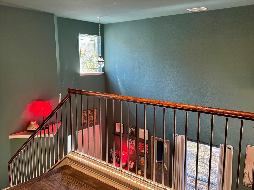 2308 Sweet Clover Drive Austin, TX 78745 - Photo 15 of 30 a view of staircase with wooden floor and a window