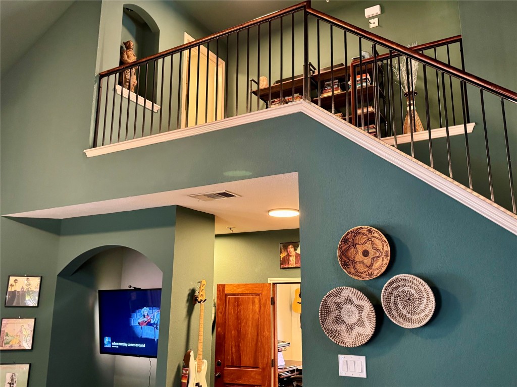 2308 Sweet Clover Drive Austin, TX 78745 - Photo 17 of 30 a view of a hallway with wooden floor and a clock