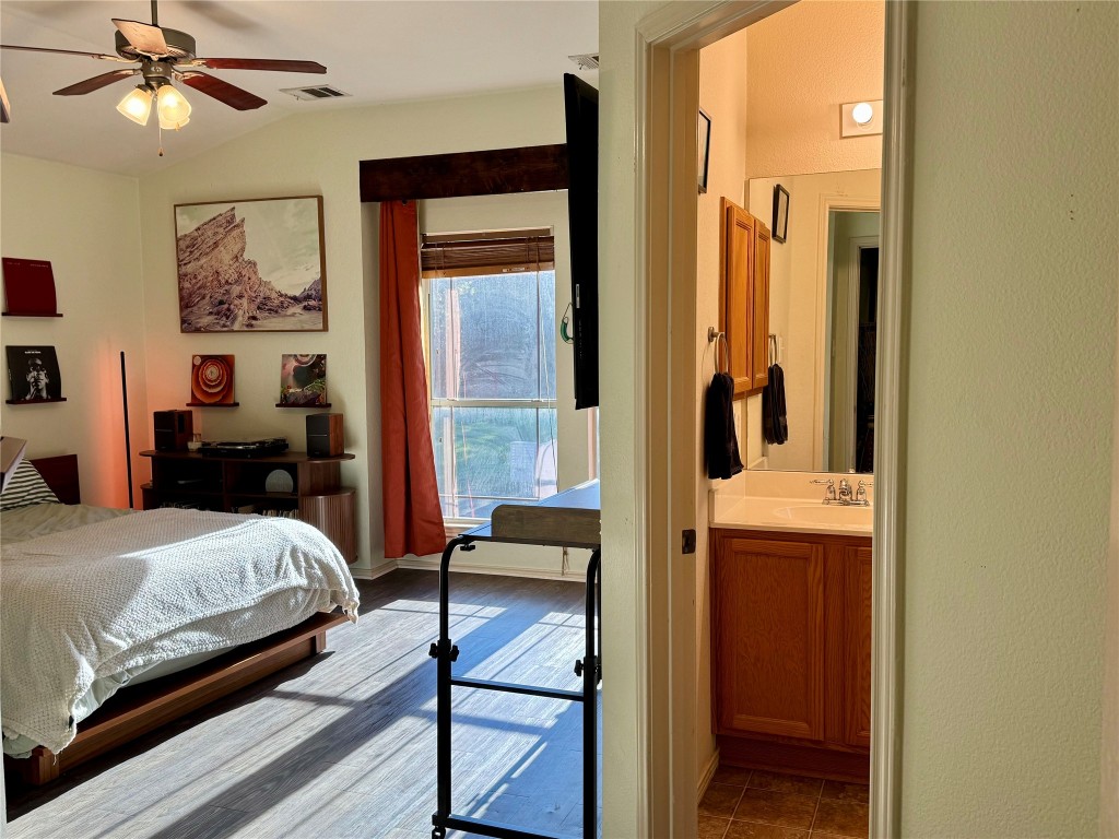 2308 Sweet Clover Drive Austin, TX 78745 - Photo 20 of 30 a bedroom with a bed and a chandelier