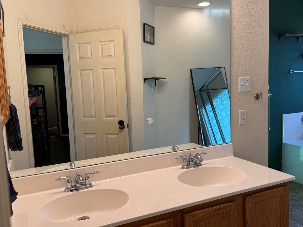 2308 Sweet Clover Drive Austin, TX 78745 - Photo 21 of 30 a bathroom with a sink and a mirror