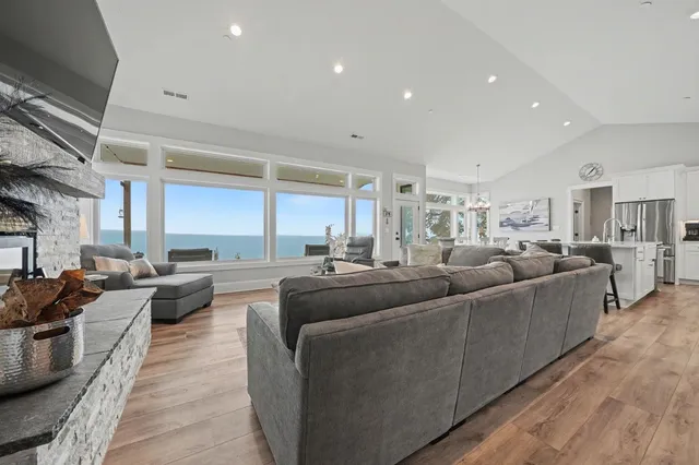 a living room with furniture a flat screen tv and a fireplace