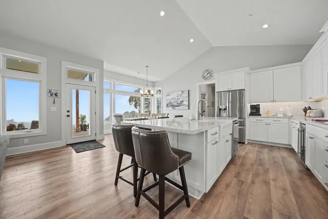 a kitchen with stainless steel appliances granite countertop a sink and cabinets