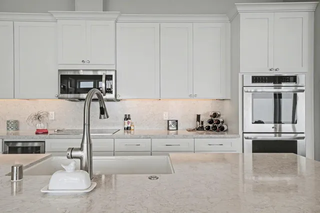 a large kitchen with a table and chairs