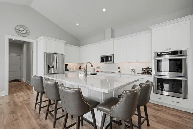 a view of a dining room with furniture a chandelier and wooden floor