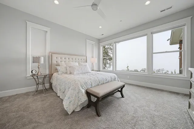 a bedroom with a large bed and a flat screen tv