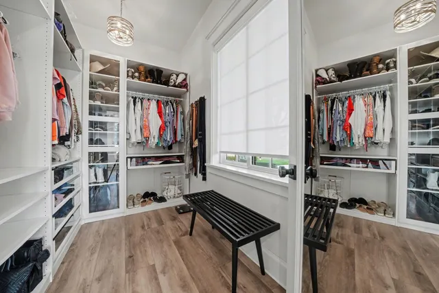 a bedroom with a bed and painting on the wall