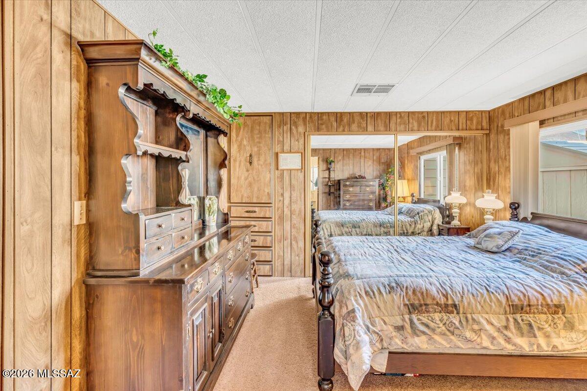 5840 West Flying W Street Tucson, AZ 85713 - Photo 17 of 38 a bed room with a bed and a large mirror