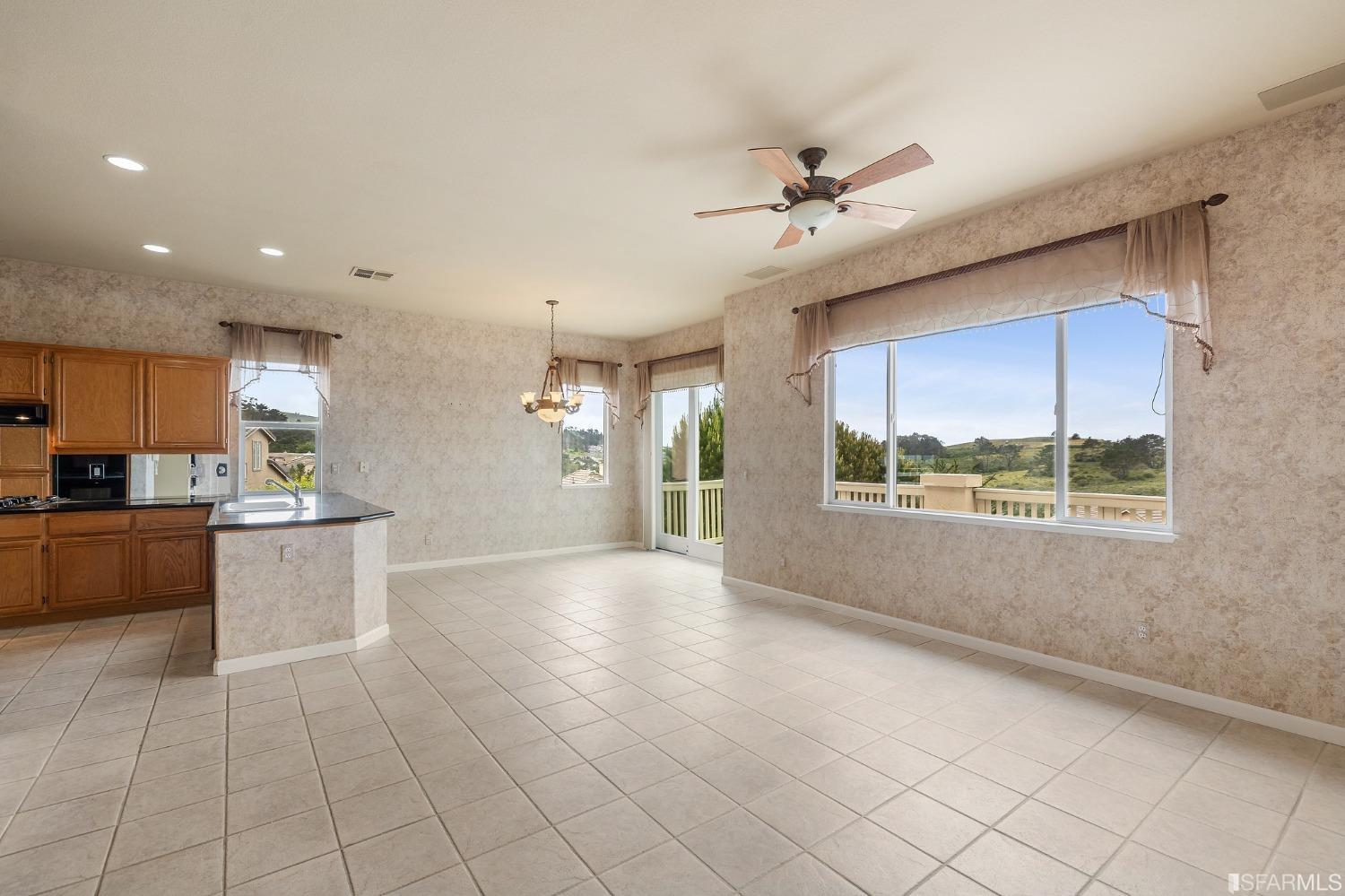 211 Sunset Court Pacifica, CA 94044 - Photo 13 of 84 a view of a kitchen with furniture and a large window
