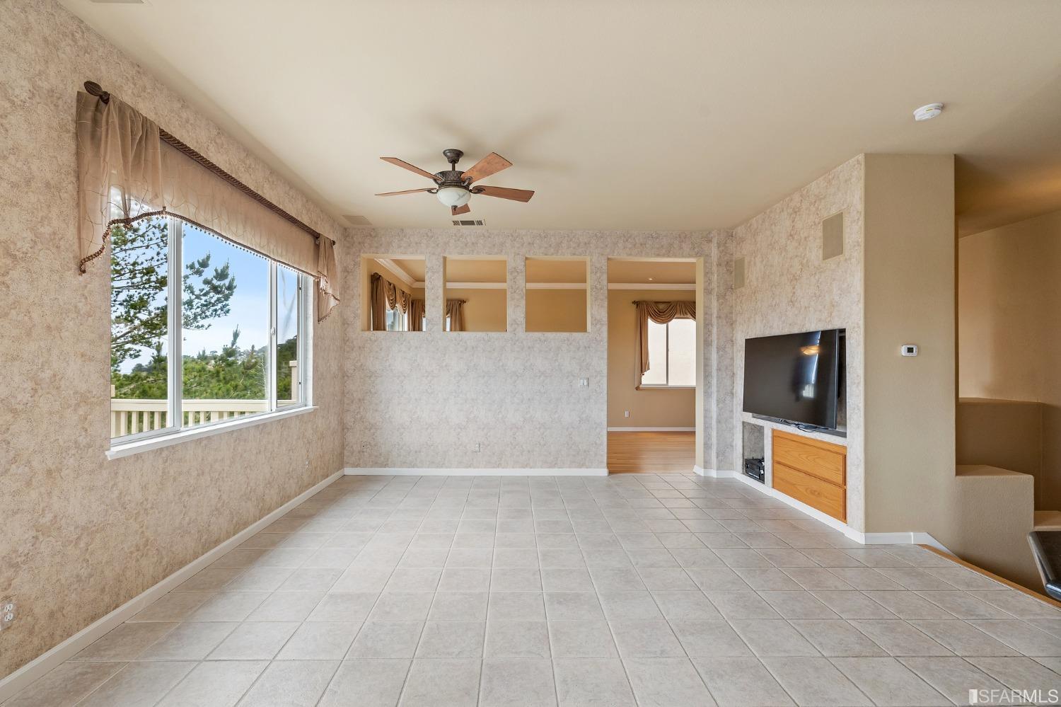 211 Sunset Court Pacifica, CA 94044 - Photo 18 of 84 a view of an empty room with a window and a kitchen