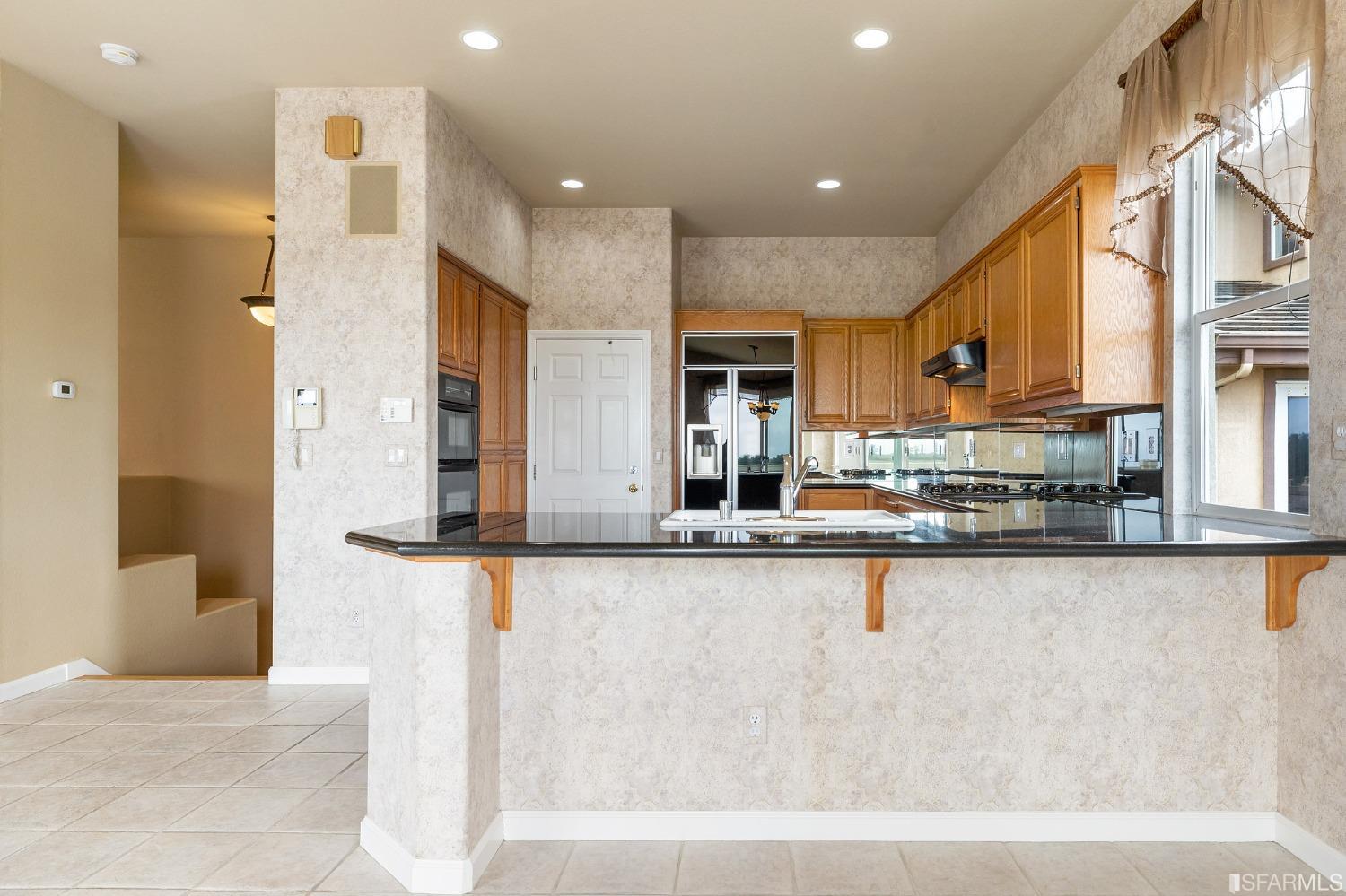 211 Sunset Court Pacifica, CA 94044 - Photo 20 of 84 a large kitchen with granite countertop a large counter top stainless steel appliances and cabinets