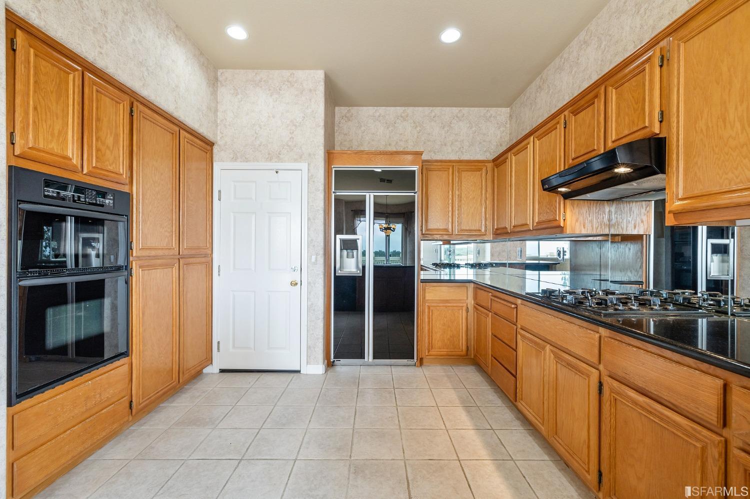 211 Sunset Court Pacifica, CA 94044 - Photo 23 of 84 a kitchen with stainless steel appliances granite countertop a refrigerator and a stove top oven