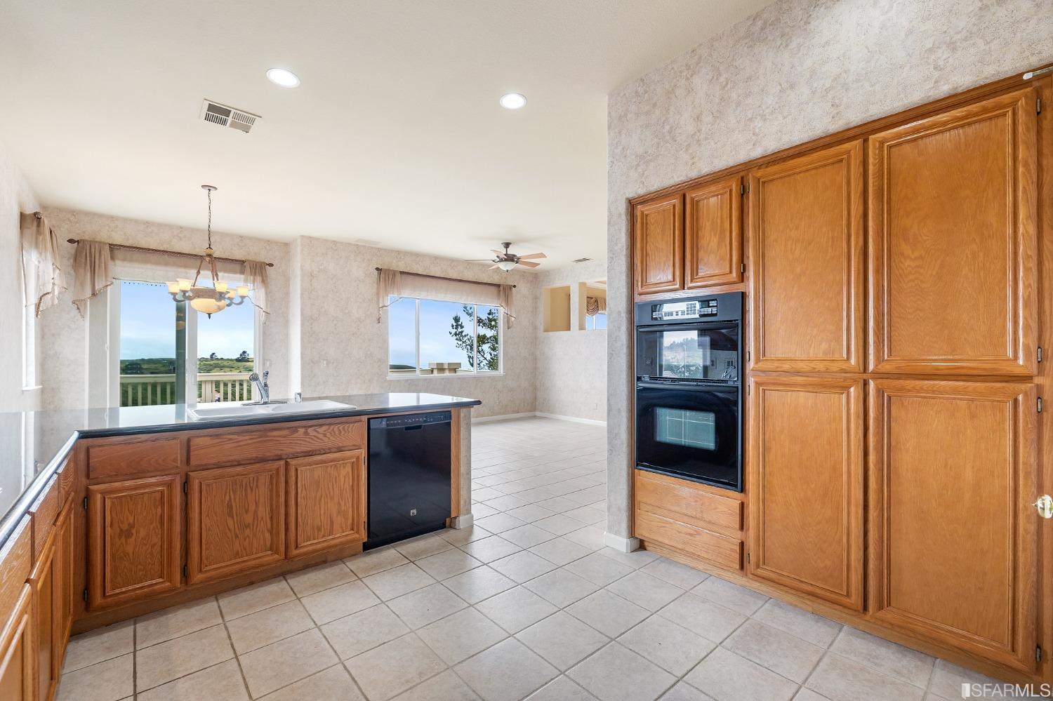 211 Sunset Court Pacifica, CA 94044 - Photo 24 of 84 a kitchen with stainless steel appliances granite countertop a refrigerator and a sink