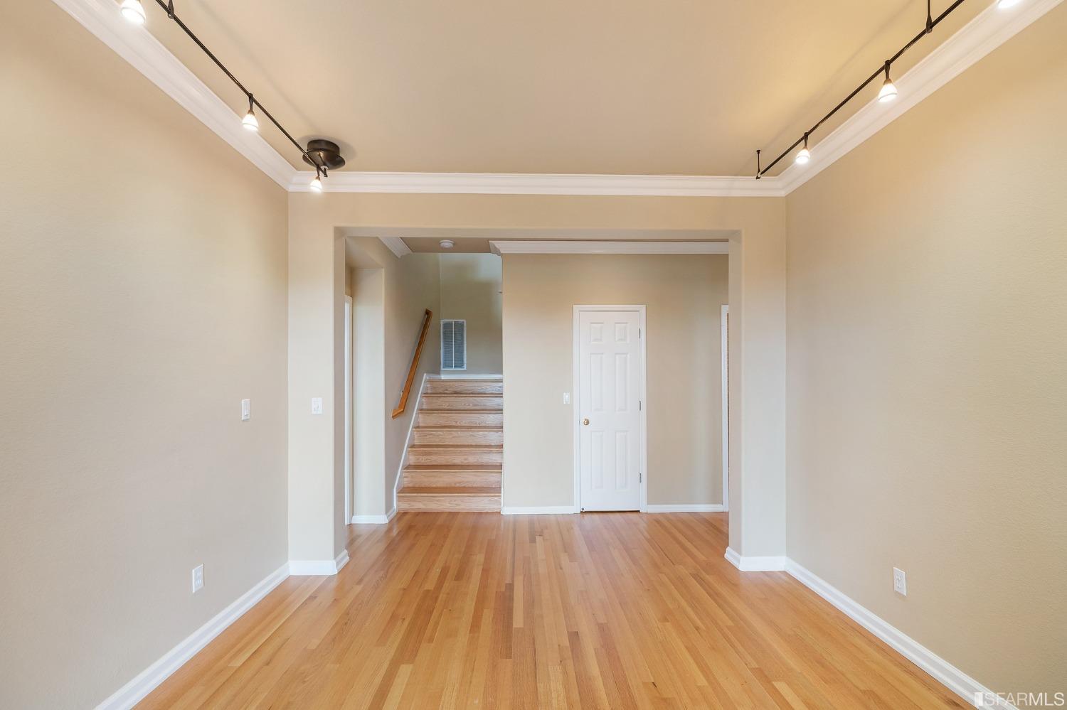 211 Sunset Court Pacifica, CA 94044 - Photo 51 of 84 a view of a hallway with wooden floor and staircase