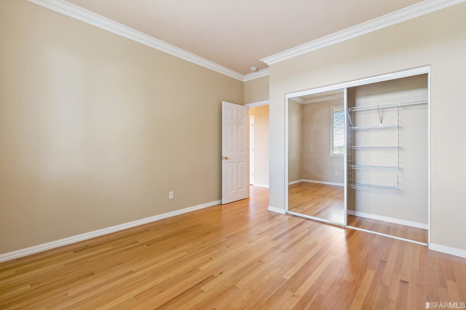 211 Sunset Court Pacifica, CA 94044 - Photo 70 of 84 an empty room with wooden floor & closet and windows