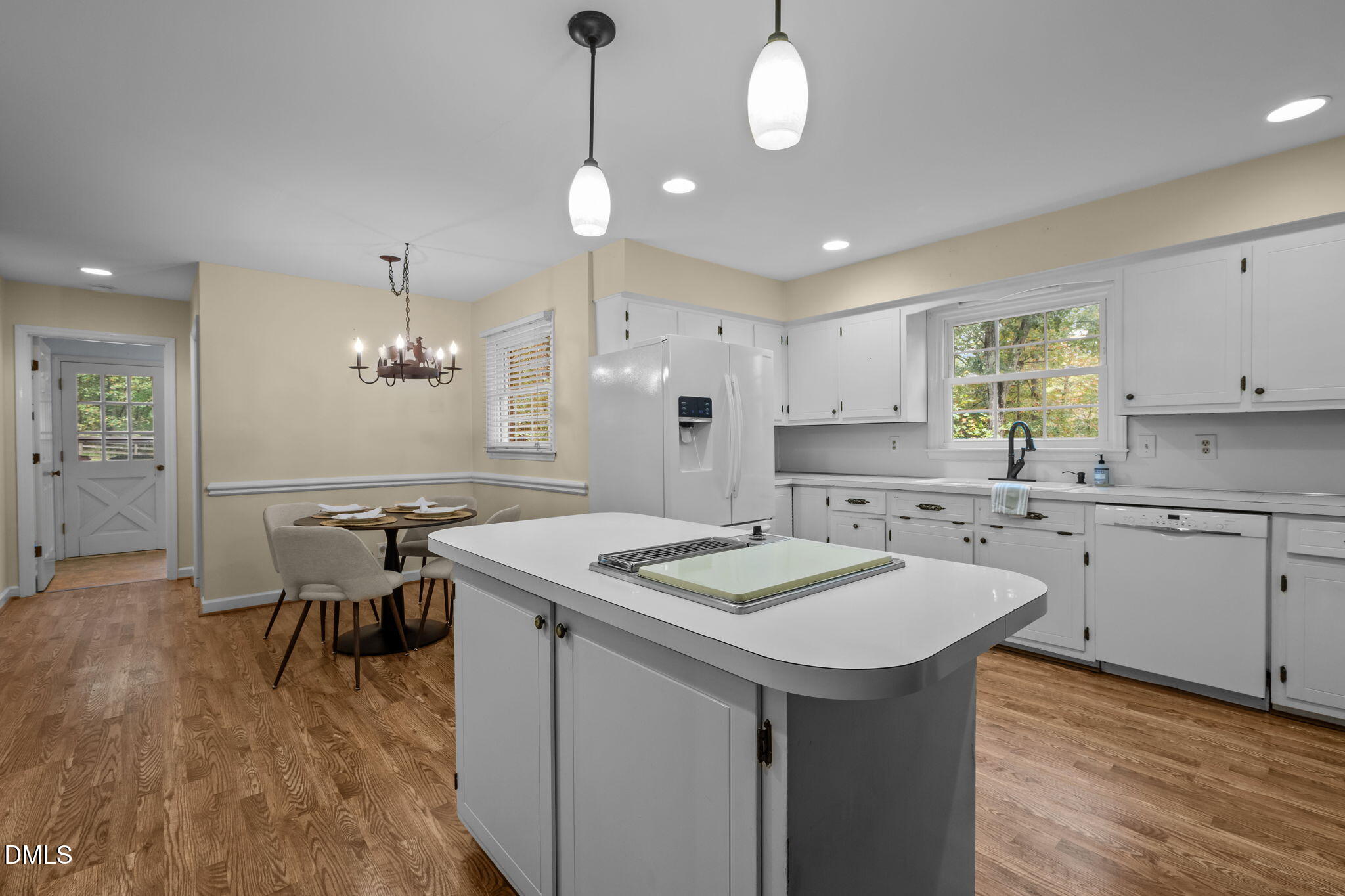 7105 Guess Road Hillsborough, NC 27278 - Photo 14 of 47 a kitchen with a sink a stove a dining table and chairs
