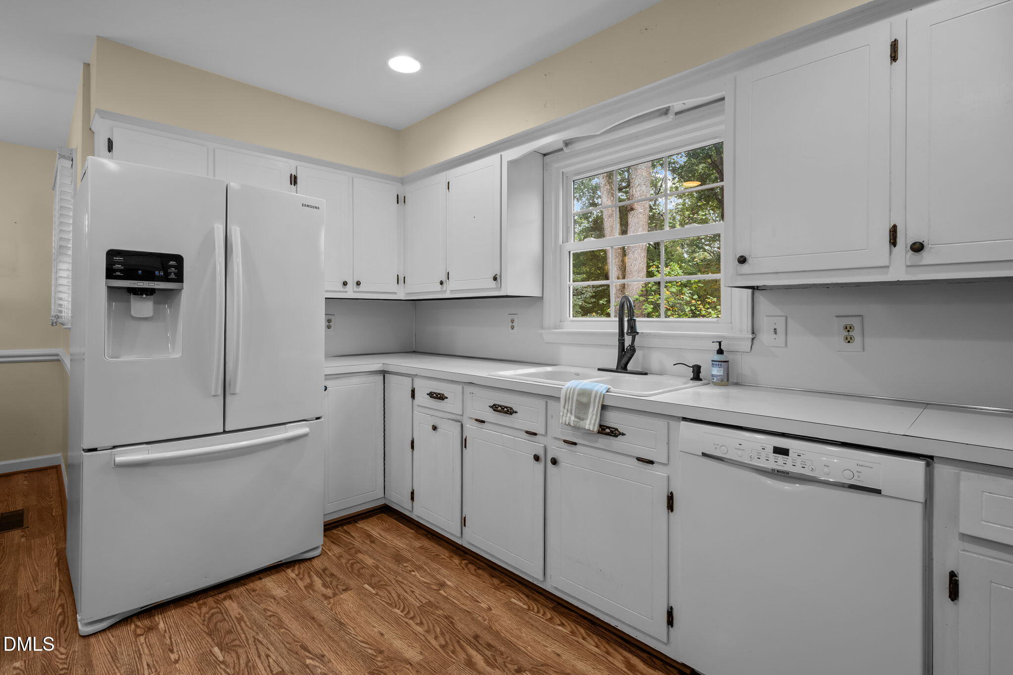 7105 Guess Road Hillsborough, NC 27278 - Photo 16 of 47 a kitchen with white cabinets and window