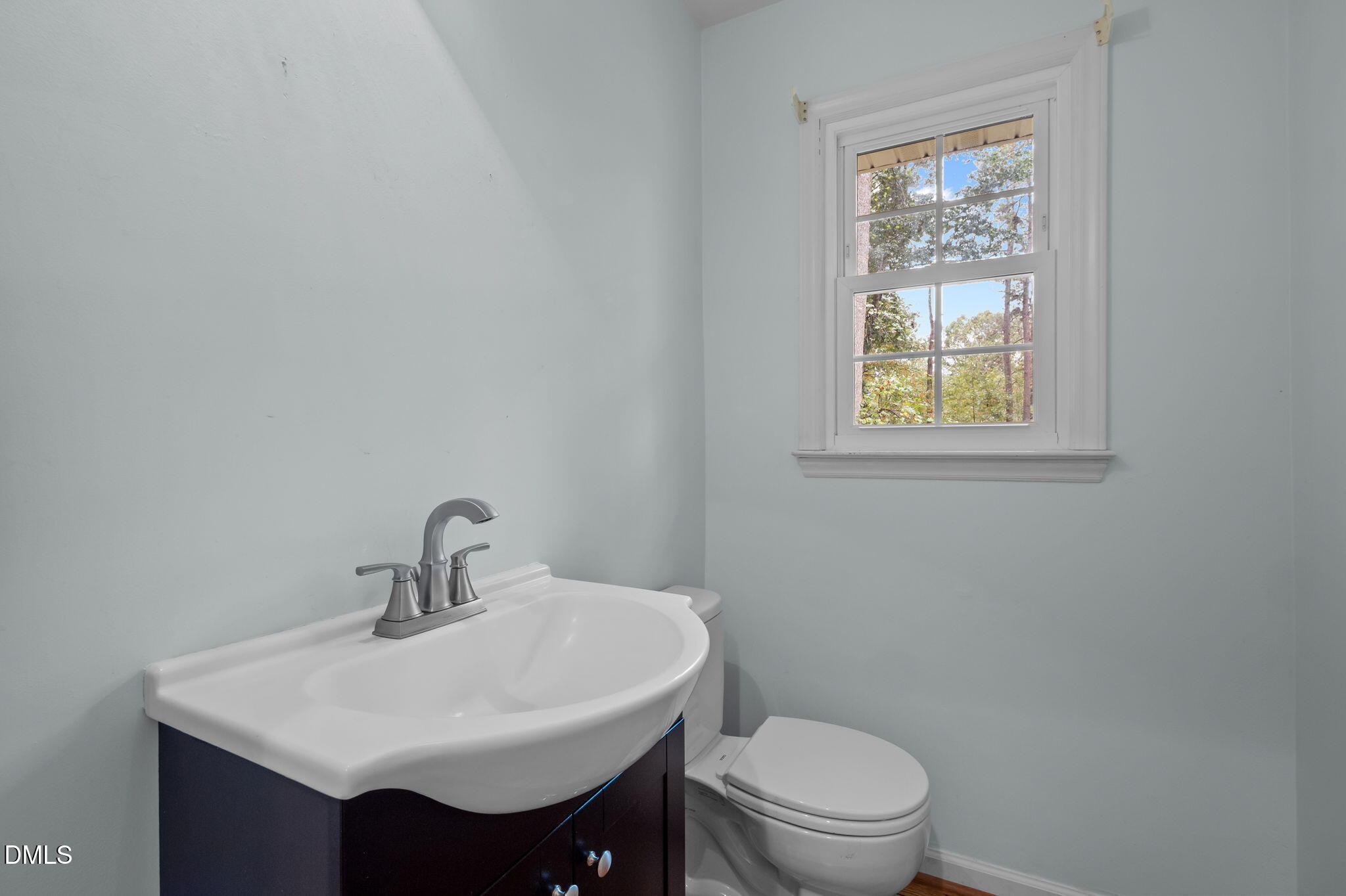 7105 Guess Road Hillsborough, NC 27278 - Photo 19 of 47 a bathroom with a sink a toilet and a window