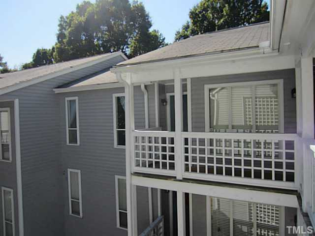 4110 Sedgewood Drive, Unit 302 Raleigh, NC 27612 - Photo 1 of 3 a view of a brick house with large windows