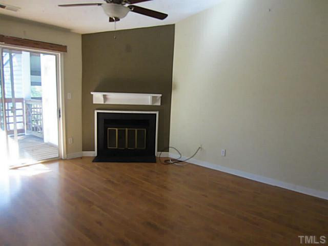 4110 Sedgewood Drive, Unit 302 Raleigh, NC 27612 - Photo 2 of 3 a view of empty room with wooden floor and fireplace