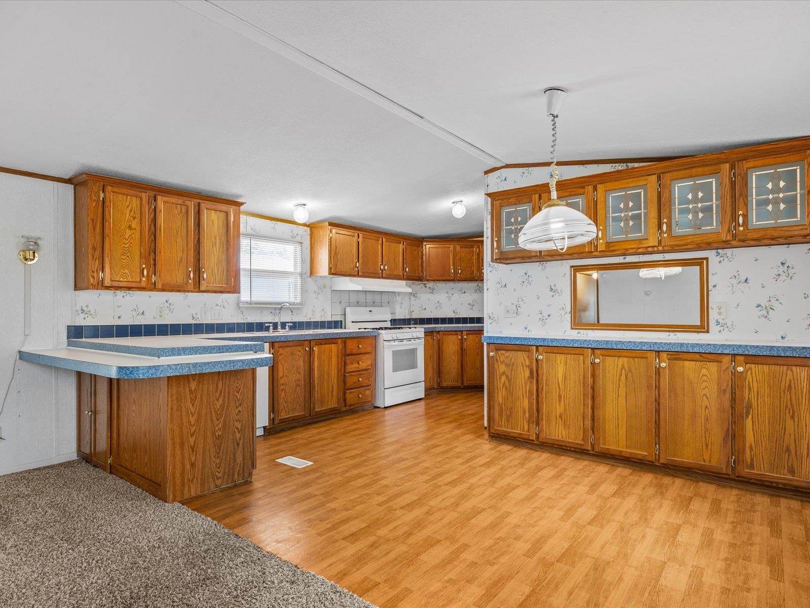 435 32 Road, Unit 713 Clifton, CO 81520 - Photo 6 of 17 a kitchen with stainless steel appliances granite countertop a sink a stove and a wooden floors