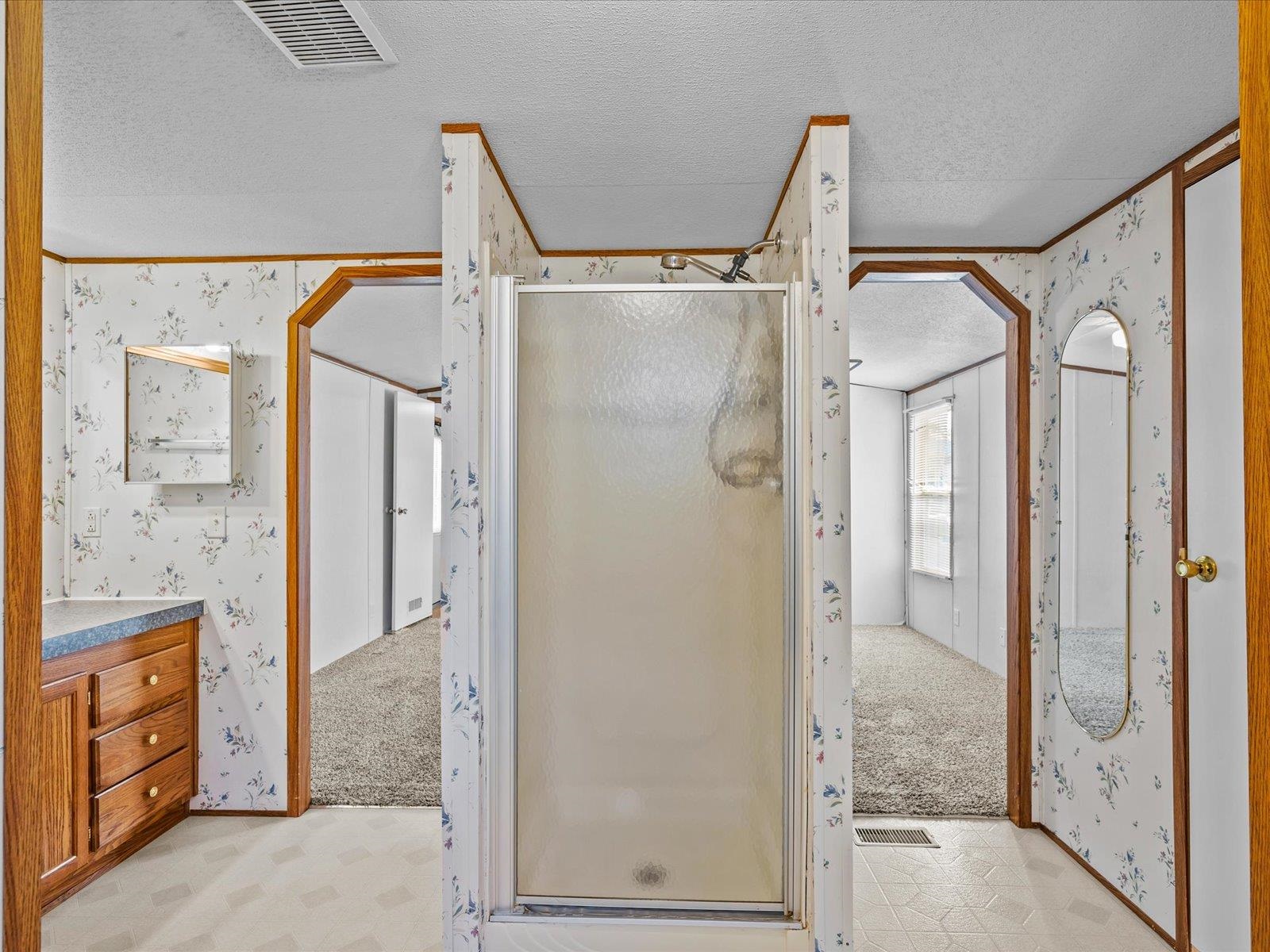 435 32 Road, Unit 713 Clifton, CO 81520 - Photo 9 of 17 a bathroom with a glass door shower a sink and a mirror