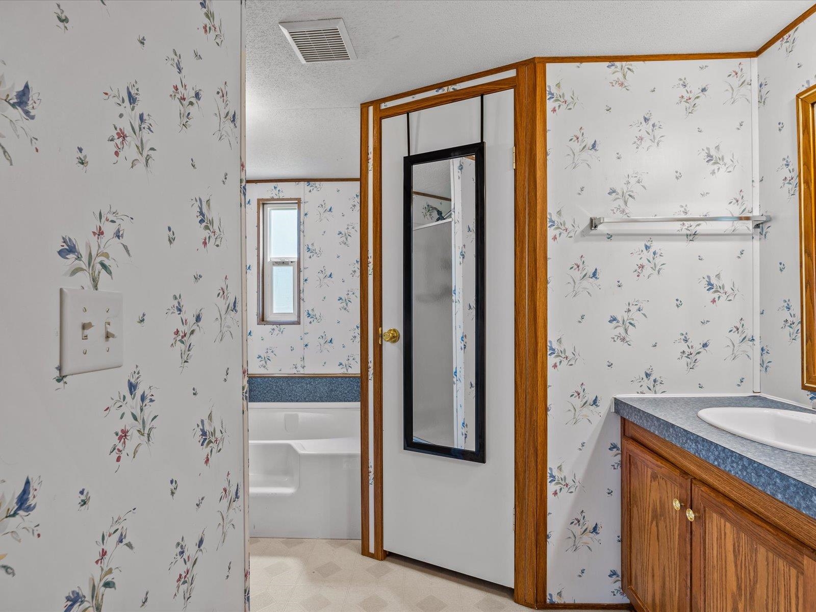435 32 Road, Unit 713 Clifton, CO 81520 - Photo 10 of 17 a bathroom with a granite countertop sink a mirror a shower and a bathtub