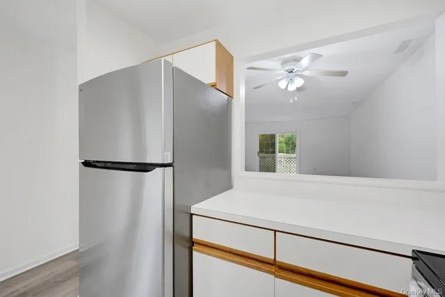 a view of a living room with a ceiling fan