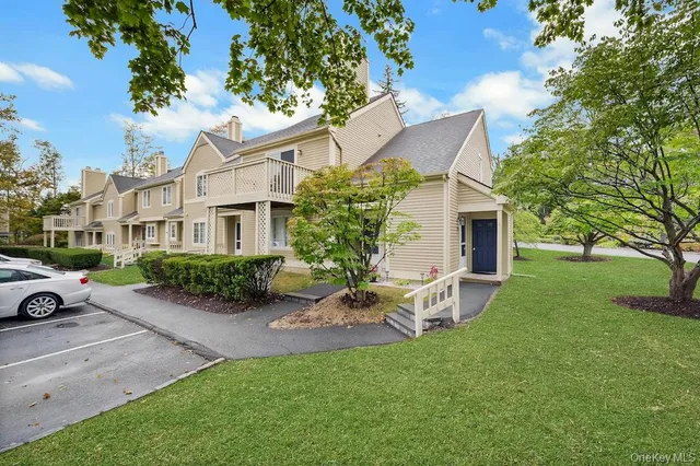 a view of a house with backyard sitting area and garden