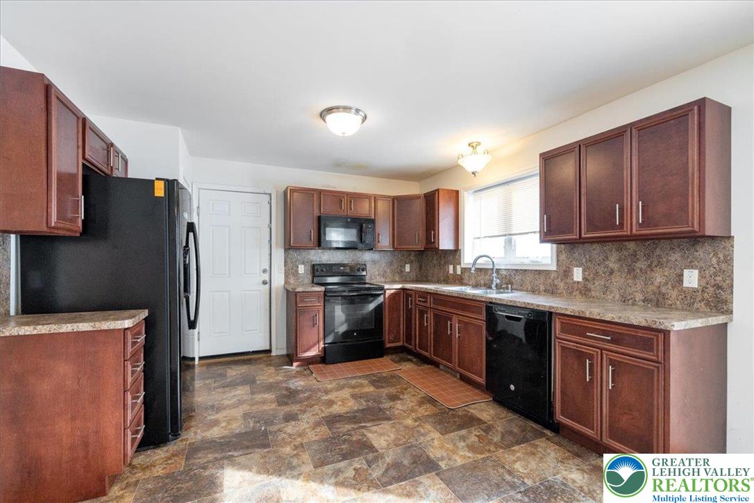 209 Buck Road East Stroudsburg, PA 18302 - Photo 5 of 25 a kitchen with stainless steel appliances granite countertop a refrigerator stove microwave and sink