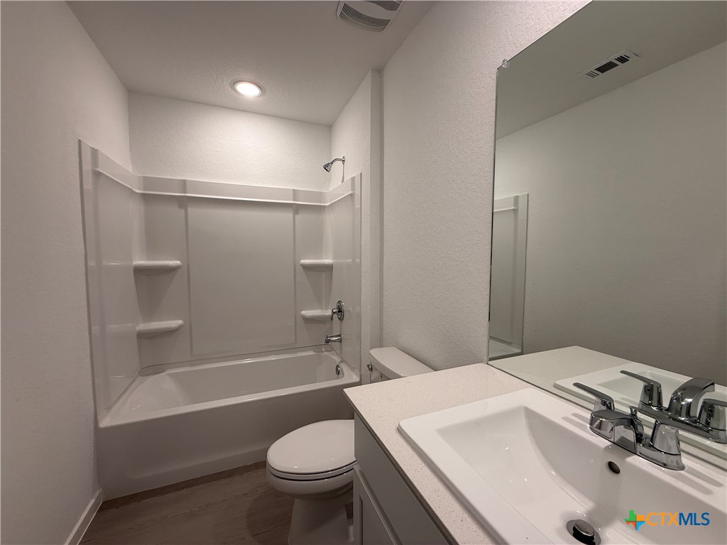 413 Moscato Road New Braunfels, TX 78130 - Photo 20 of 28 a bathroom with a sink toilet and shower